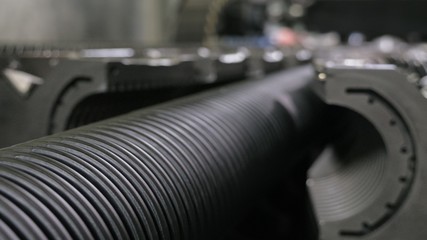 Manufacture of plastic water pipes. Manufacturing of tubes to the factory. The process of making...