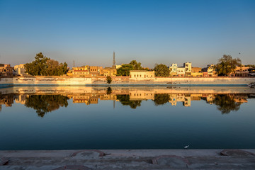 Naklejka premium Waterfront Reflection of Houses in Bikaner India 