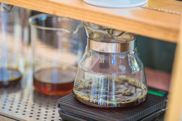 Drip brewing, filtered coffee, or pour-over is a method which involves pouring water over roasted, ground coffee beans contained in a filter, Drip or brewed coffee on paper dripping bag on a cup