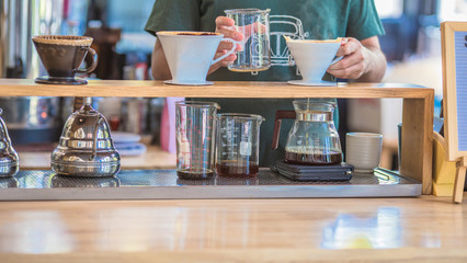 Drip brewing, filtered coffee, or pour-over is a method which involves pouring water over roasted, ground coffee beans contained in a filter, Drip or brewed coffee on paper dripping bag on a cup