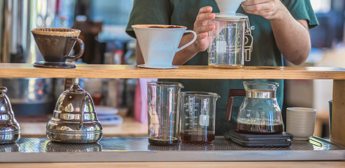Drip brewing, filtered coffee, or pour-over is a method which involves pouring water over roasted, ground coffee beans contained in a filter, Drip or brewed coffee on paper dripping bag on a cup