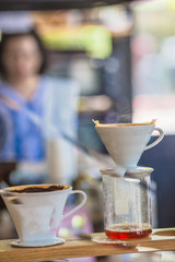Drip brewing, filtered coffee, or pour-over is a method which involves pouring water over roasted, ground coffee beans contained in a filter, Drip or brewed coffee on paper dripping bag on a cup
