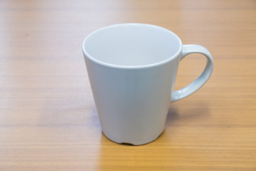 Ceramic mug on the wood table.