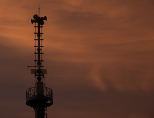 Warning pole and evening sky.
