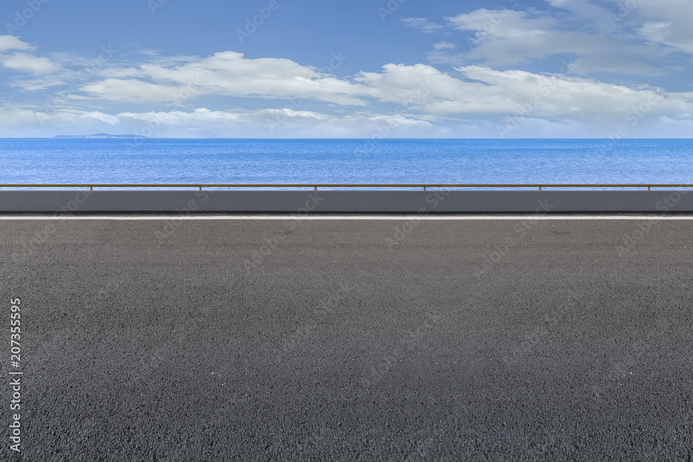 Wall mural asphalt pavement and sea