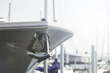 white yacht and the metal anchor against the blue sky and clouds © DMITRY TILT