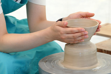 轆轤を回して陶器を作る女性