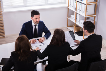 Businesspeople Having Conversation In Office