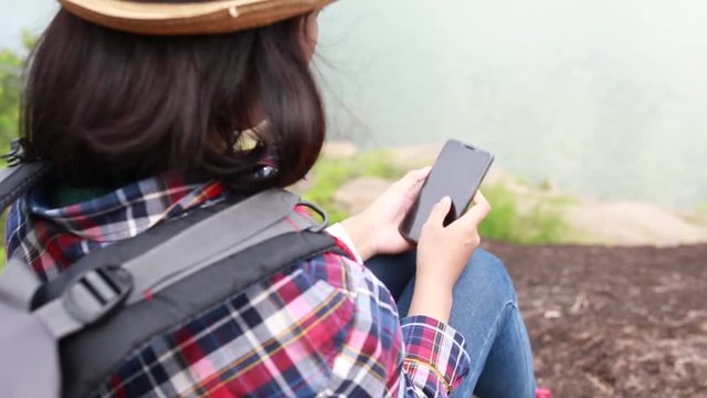Hipster style women use smartphone searching map or GPS for travel in of her HD format