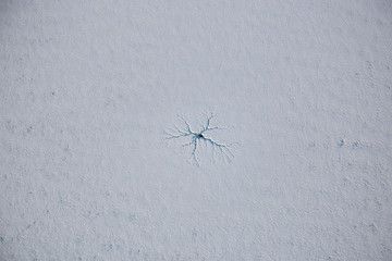 Aerial view of the ice crack in a frozen lake. Taken in Garibaldi, North of Vancouver, British Columbia, Canada