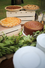 Wedding Dessert Bar with Cookies, Cakes, and Pies Rustic Wedding Decor Pink, Peach, Purple, and Green Floral Centerpieces on a Wooden Farm Table