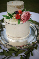 White Naked Layered Wedding Cake with Pink Peony and Roses on a Silver Platter