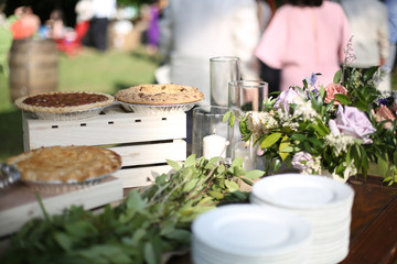 Wedding Dessert Bar with Cookies, Cakes, and Pies Rustic Wedding Decor Pink, Peach, Purple, and Green Floral Centerpieces on a Wooden Farm Table