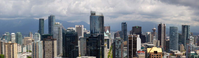 Fototapeta premium Downtown Vancouver, British Columbia, Canada - May 10, 2018: Aerial panoramic view of the modern city during a cloudy day.