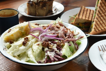 Fresh and healthy salad on a wooden table