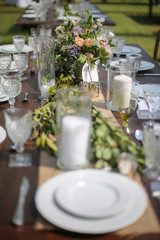 Rustic Wedding Decor Pink, Peach, Purple, and Green Floral Centerpieces on a Wooden Farm Table