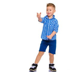 The boy points a finger at something.