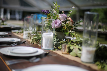 Rustic Wedding Decor Pink, Peach, Purple, and Green Floral Centerpieces on a Wooden Farm Table