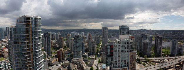 Fototapeta premium Aerial panoramic view of a beautiful modern cityscape during a cloudy day.Taken in Downtown Vancouver, British Columbia, Canada. High Quality and Resolution
