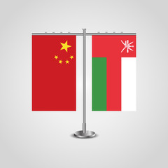 Table stand with flags of China and Oman.Two flag. Flag pole. Symbolizing the cooperation between the two countries. Table flags