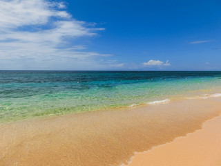 Fototapeta na wymiar The sea and sand at Bamboo Beach in Jamaica