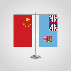 Table stand with flags of China and Fiji.Two flag. Flag pole. Symbolizing the cooperation between the two countries. Table flags