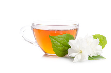 Glass cup of Tea with jasmine flowers and leaves isolated on white background