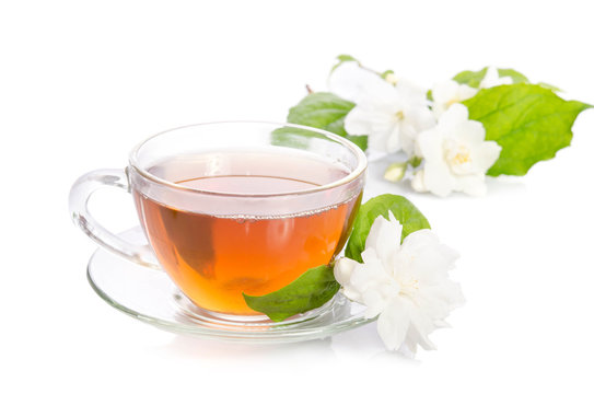 Glass cup of Tea with jasmine flowers and leaves isolated on white background