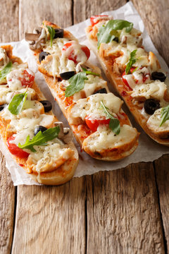 Delicious hot sandwich baguette baked with chicken, cheese, tomatoes, olives and mushrooms. vertical