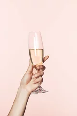 Foto op Aluminium cropped shot of woman cheering by champagne glass isolated on pink background © LIGHTFIELD STUDIOS