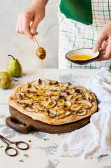Female Drizzling Pear Pizza with Honey