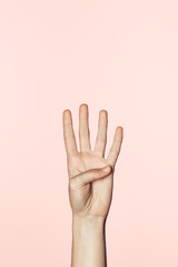 cropped shot of woman counting from one to four by hand isolated on pink background