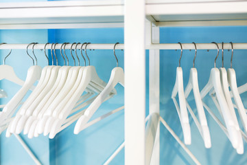 White hangers in the empty wardrobe
