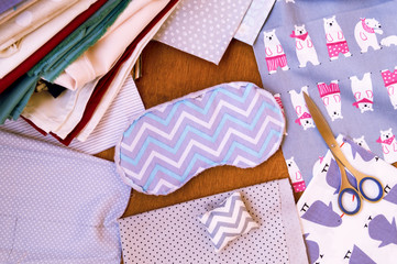 A set of cute fabrics and accessories for sewing on the table