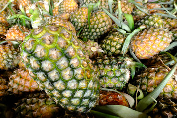 Pineapples for sell in market and A lot of pineapple fruit background.