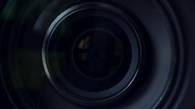 Video camera lens close up, camcorder zooming in