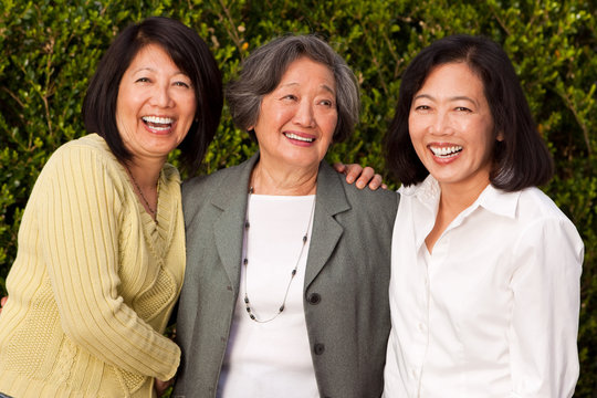 Mature Asian mother and her adult daughters.