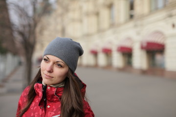 beautiful young girl walks through winter Moscow in warm clothes