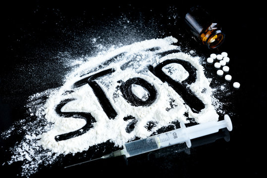 Drugs, syringe and pills. The inscription "stop" - concept stop drug addiction