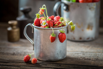 Delicious and fresh wild strawberries in the old wooden box