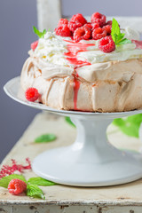 Delicious and crispy Pavlova cake with meringue and raspberry mousse