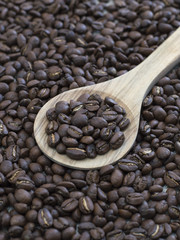 roasted coffee beans on a kitchen table. 