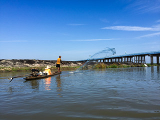 Fisherman Catching Fish With Net