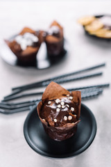 Sweet cupcakes with chocolate chips on light table