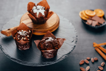 Sweet chocolate muffins on dark slate board