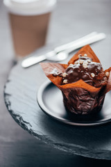 Sweet chocolate cupcake on slate board background