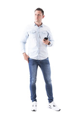 Adult caucasian elegant thinking business man holding mobile phone and looking away. Full body isolated on white background. 