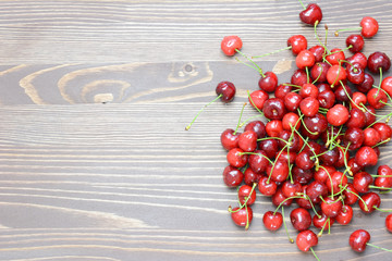 Deep dark cherries fruit on a wooden background. Copyspace.