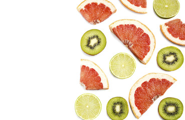 cut lime kiwi fruit and grapefruit on a white background