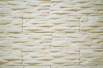 background image of a white decorative wall of thin stones
